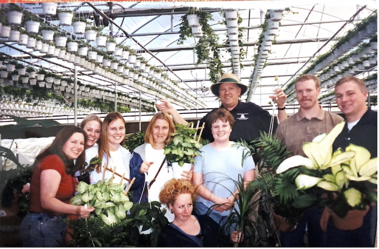 A photo of AETI students and faculty at a greenhouse. 